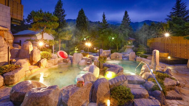 A hot spring area with large rocks, a small pool, and a wooden structure. - TAOYA Kisoji  (Nagiso)