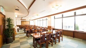 A spacious dining area with multiple tables and chairs, large windows, and a checkered floor pattern. - Iidaya (Matsumoto)