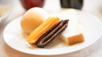 A plate with a sandwich and a pastry.