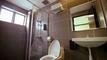 Un baño moderno con inodoro, ducha y lavamanos.