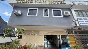 The exterior of Tiong Nam Hotel with a signboard, air conditioning units, and a covered entrance. - Tiong Nam Hotel Near Pasir Gudang (Pasir Gudang)