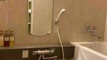 A bathroom with a bathtub, a shower, a toilet, and a sink.