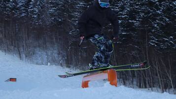 A person snowboarding on a rail.