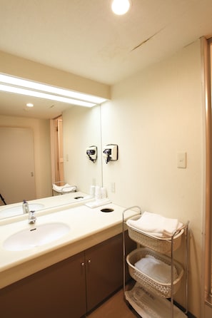 A bathroom with a double sink, a mirror, a towel rack, and a laundry bag. - Hotel Edel Warme (Furano)