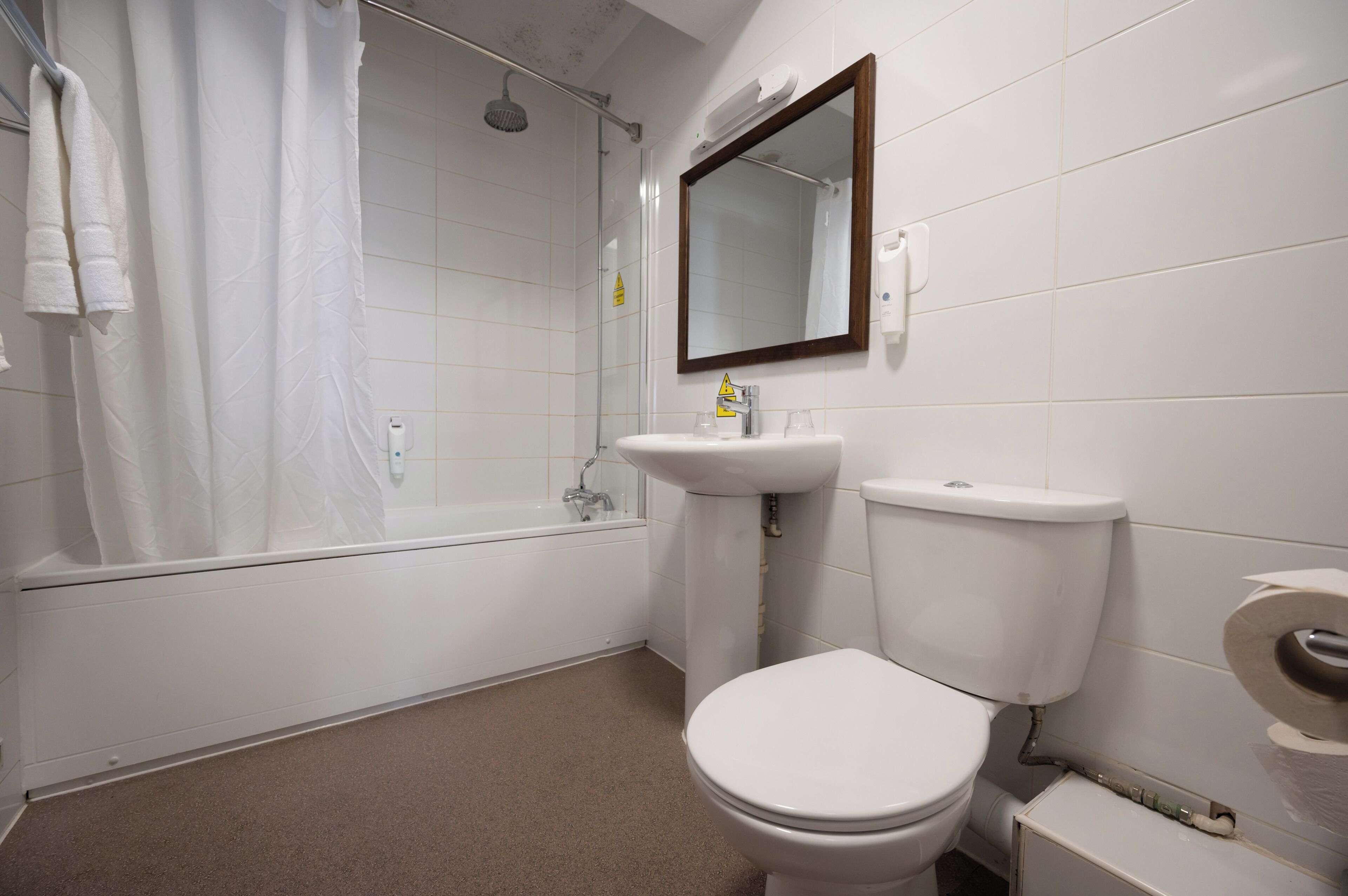 A bathroom with a bathtub, a sink, and a toilet.