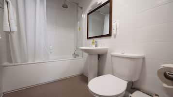 A bathroom with a bathtub, a sink, and a toilet.