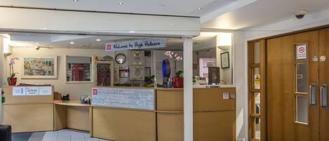 A reception desk with a sign reading "Welcome to High Holborn."