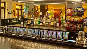 A bar area with a sign listing various cocktails and their prices. - Safestay London Elephant & Castle (London)