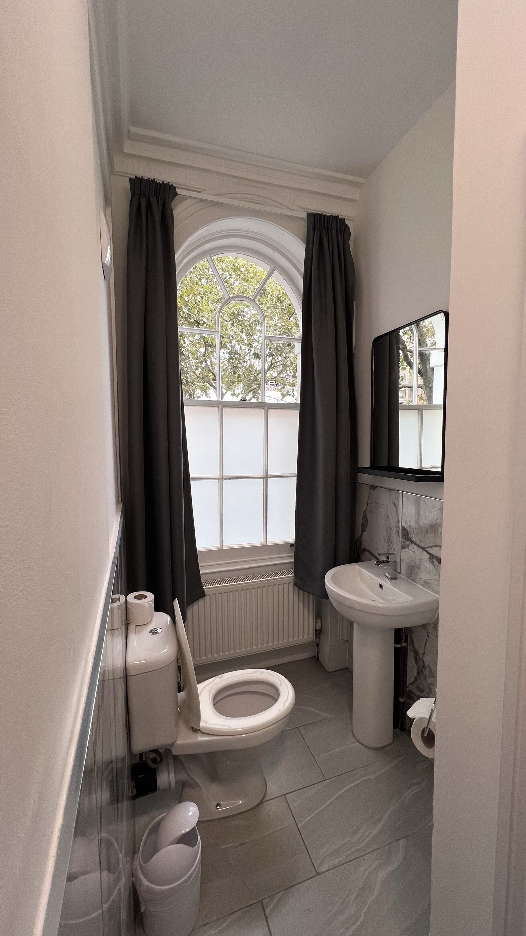A bathroom with a toilet, bidet, and sink.
