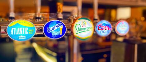 A bar with various beer taps including brands like Atlantic Pale Ale, Blue Moon Belgian White, Staropramen, and Coors Light.