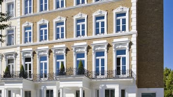Classic architecture with a symmetrical facade, evenly spaced windows, and decorative moldings.