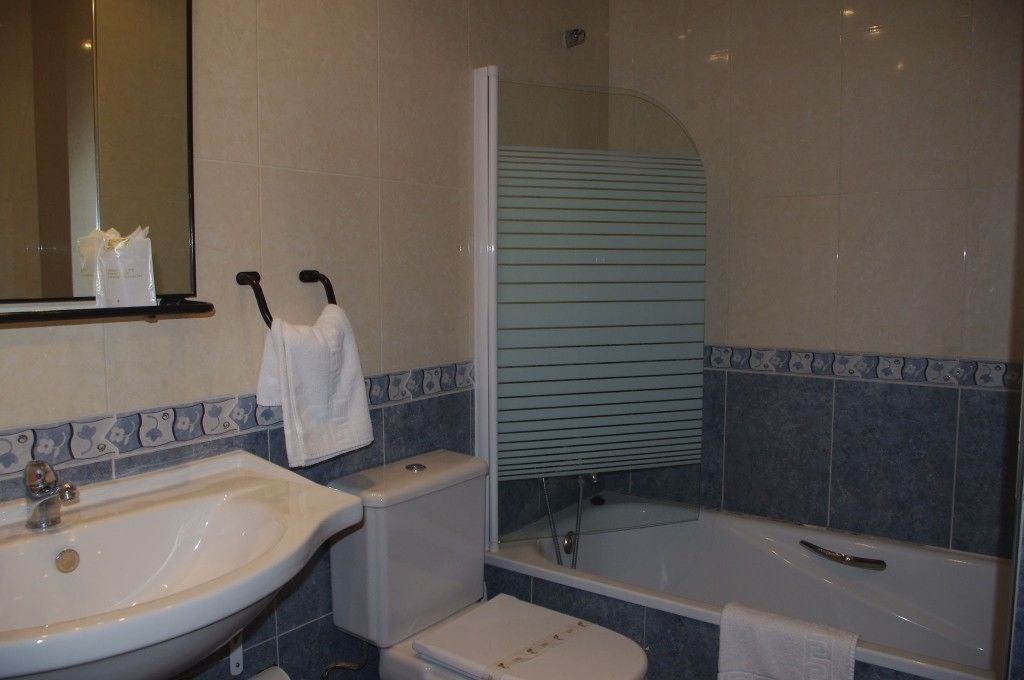 A bathroom with a sink, toilet, and bathtub.
