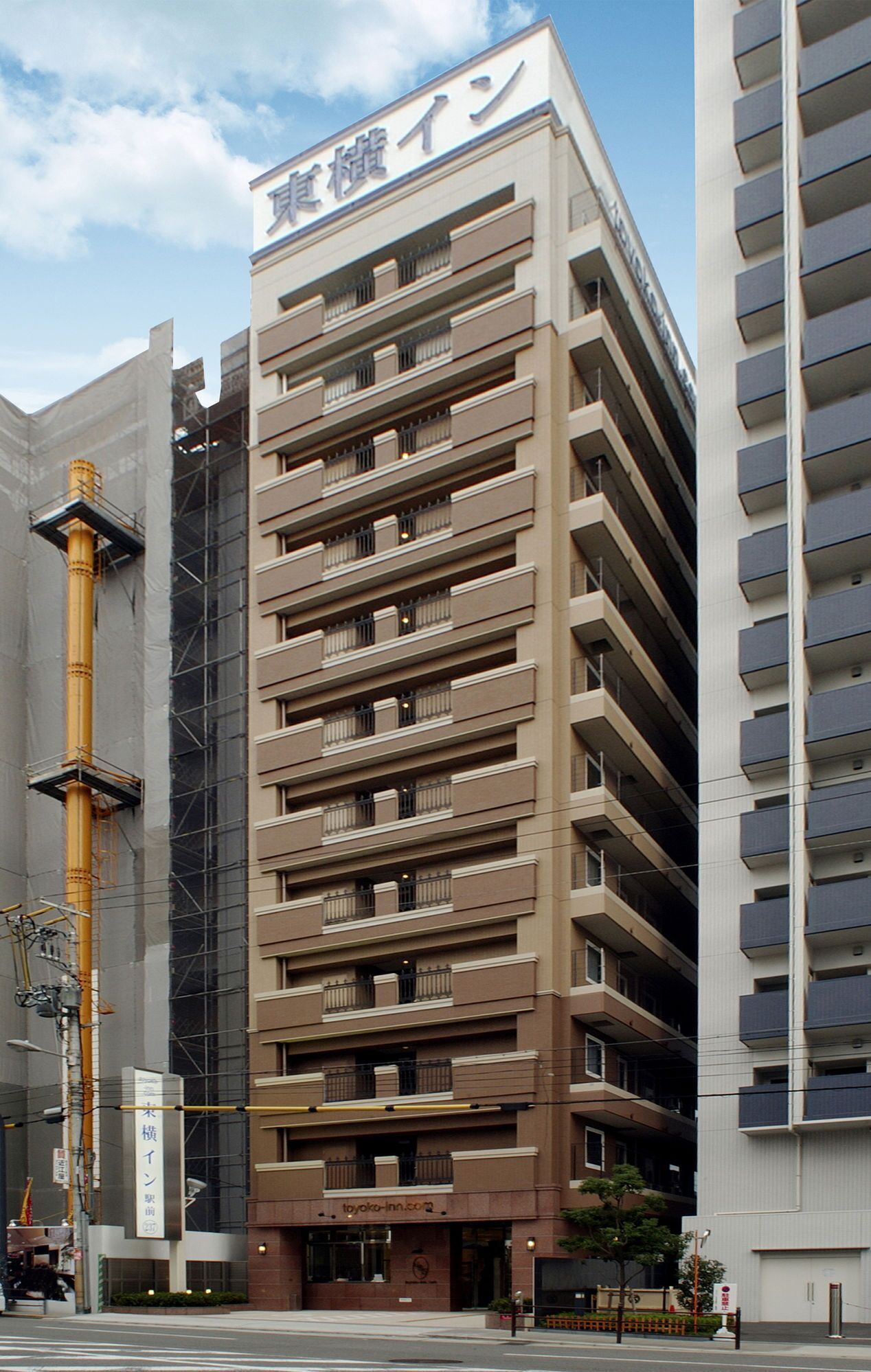 A multi-story building with a sign indicating it is a hotel.