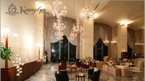 A luxurious hotel lobby with ornate chandeliers, elegant furniture, and a patterned floor. - Hotel Kawakyu (Shirahama)