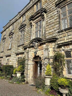 A historic stone building with multiple windows and a central entrance. - Moresby Hall (Whitehaven)