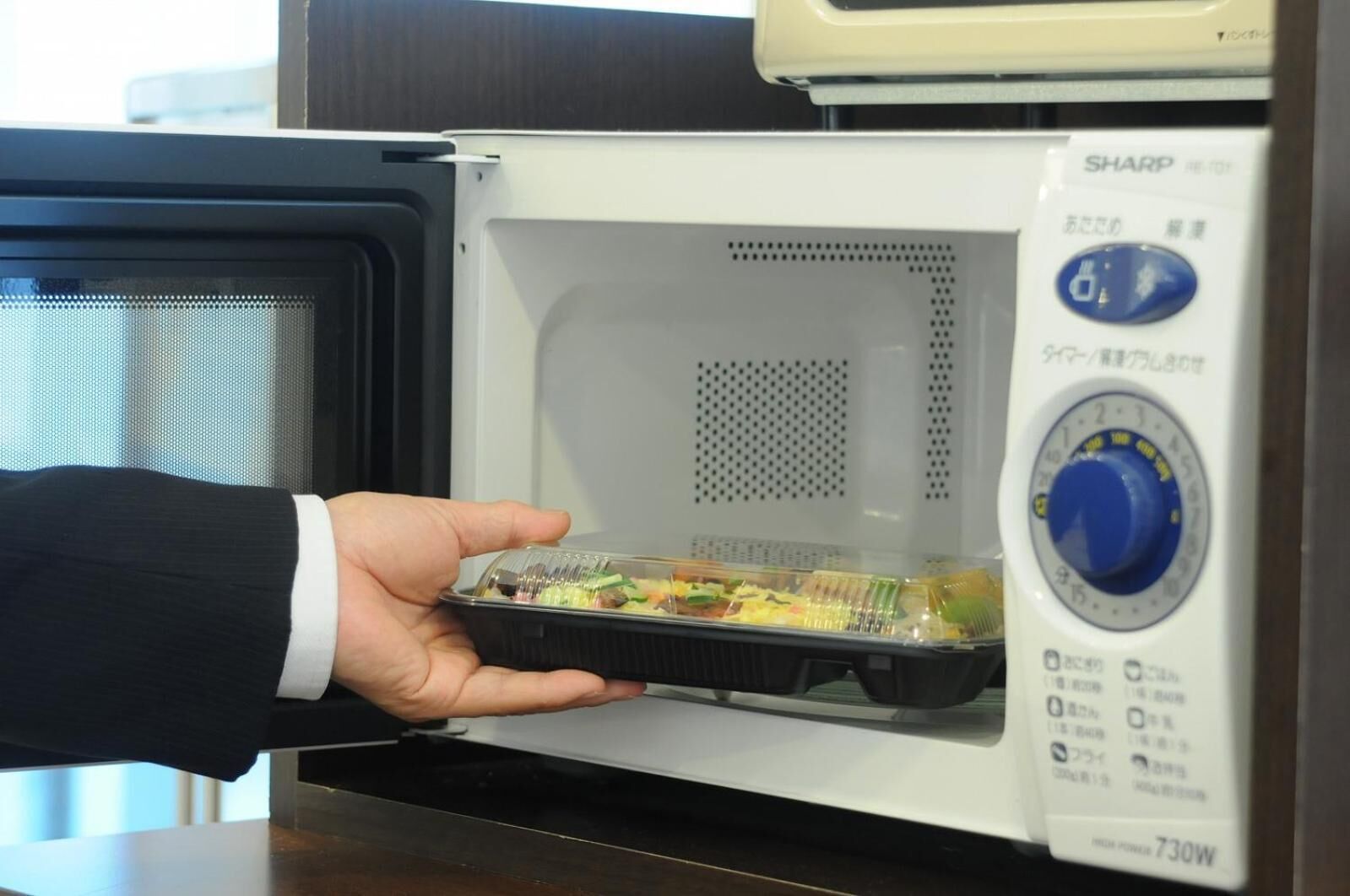 A microwave with a digital display and a control knob.