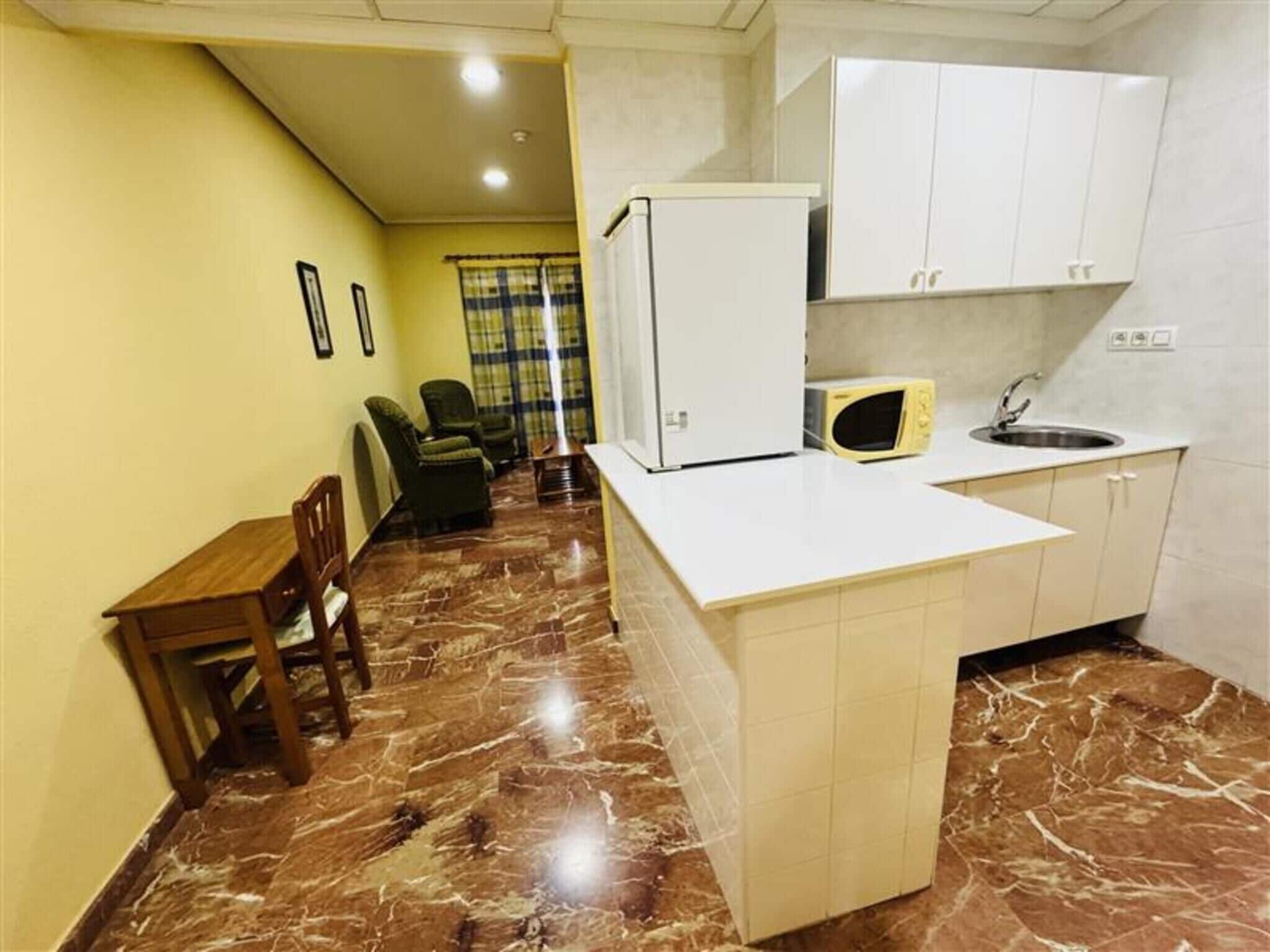 Suite Room | Private kitchen | Fridge, microwave, dining tables