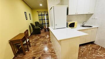 Suite Room | Private kitchen | Fridge, microwave, dining tables