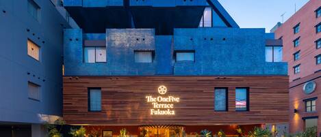 A modern hotel with a prominent terrace and a sign reading "The OneFive Terrace Fukuoka."