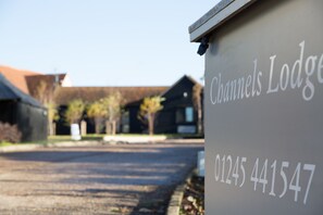 A sign for Channels Lodge with a contact number. - Channels Hotel (Chelmsford)
