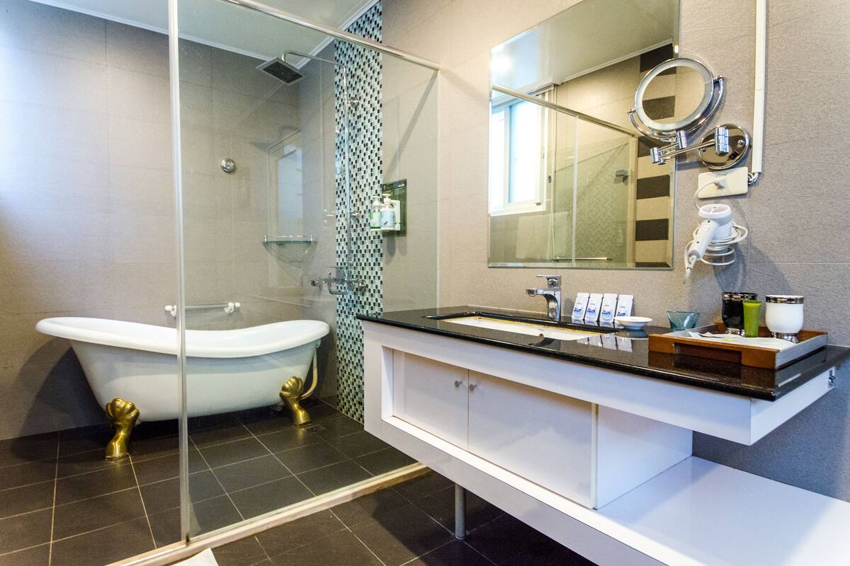 deluxe quadruple room | bathroom | separate bathtub and shower, free toiletries, hair dryer, slippers
