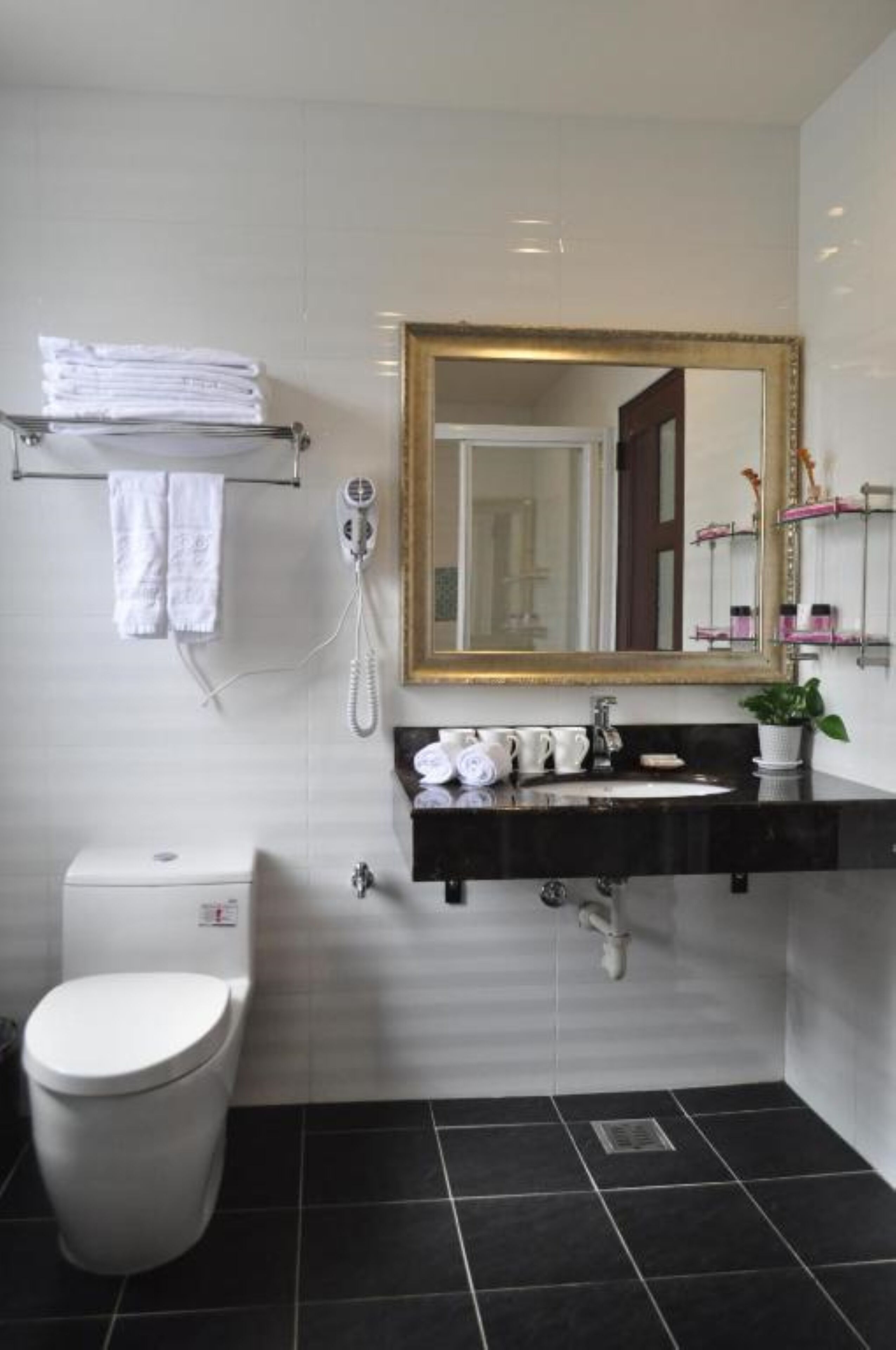 family room, partial lake view | bathroom | separate bathtub and shower, hair dryer, slippers, towels