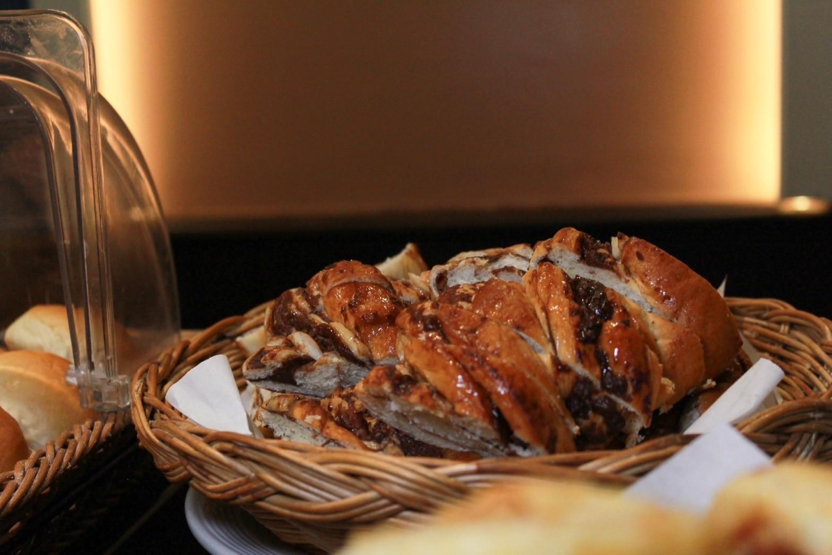 A basket of sliced meats and bread, likely for a buffet or catering service.
