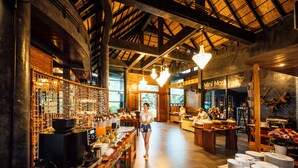 A spacious cafe interior with a high ceiling, wooden beams, and a central serving area. - Andalay Beach Resort Koh Libong (Ko Libong)