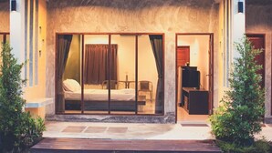 A modern hotel room with a bed, a desk, and a television. - Palm Garden Resort (Sikao)