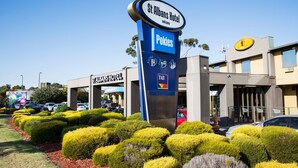 A hotel entrance with a sign for St Albans Hotel and Pokies, featuring a modern building facade and landscaped garden. - Nightcap at St Albans Hotel (St. Albans)