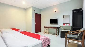 A hotel room with two beds, a desk, a chair, a TV, and a wardrobe.