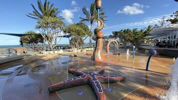 A water feature with a starfish design, a spiral structure, and a flag on top.