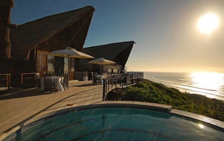 2 outdoor pools, pool loungers. Massinga Beach Lodge