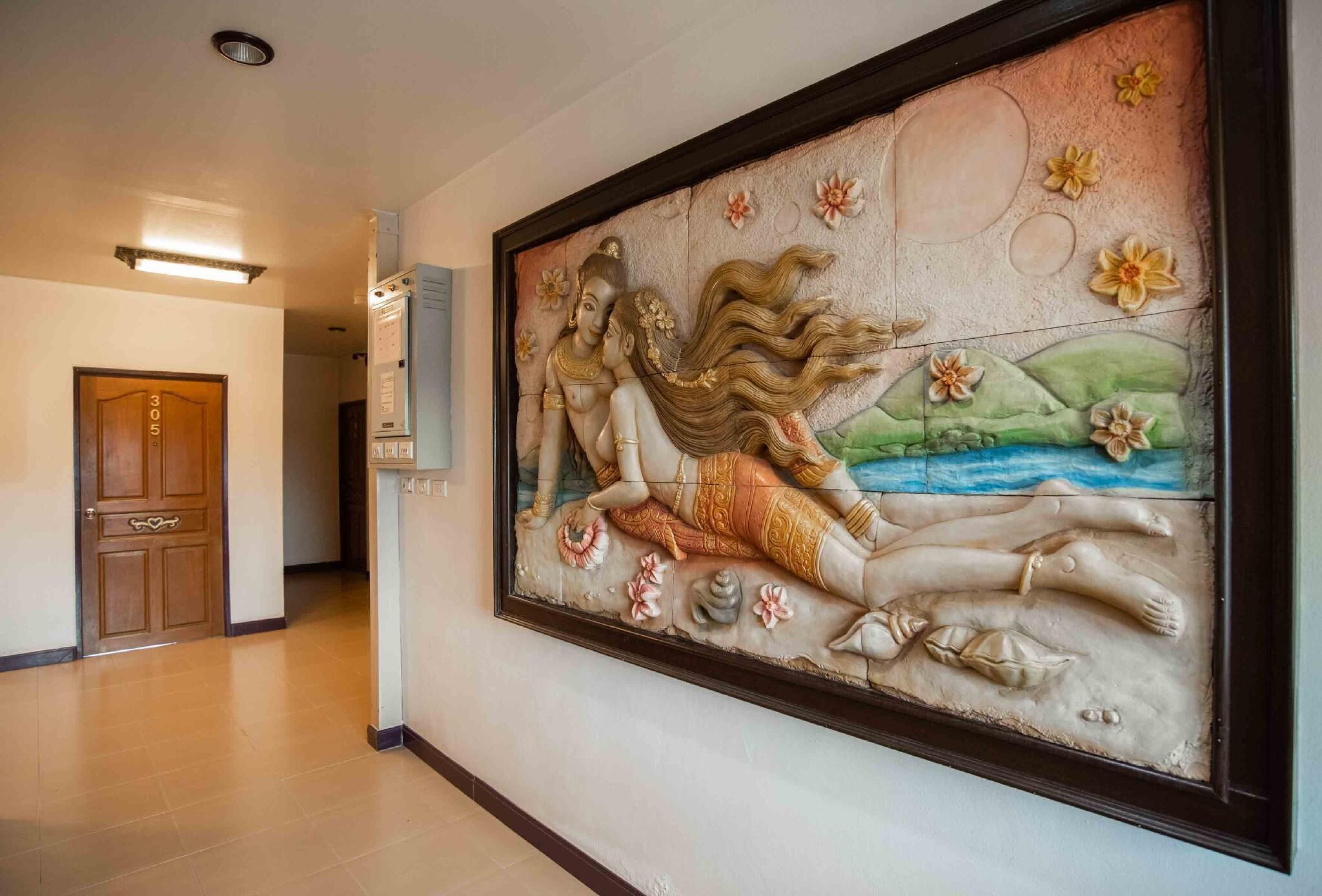 A hallway with a large mural of a reclining figure and flowers. A door labeled "305" is visible to the left.