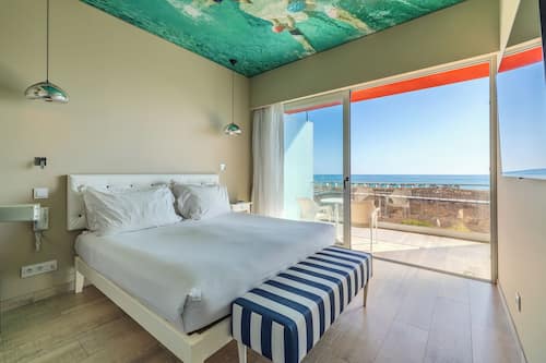 Suite, uitzicht op zee | Een minibar, een kluis op de kamer, gratis wifi, beddengoed