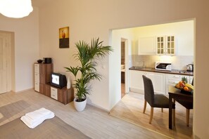 A modern apartment with a living area, a kitchen, and a dining space.