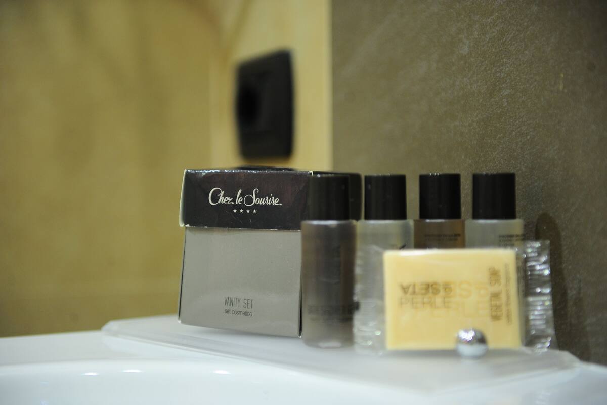 A vanity set with a mirror and various cosmetic products.