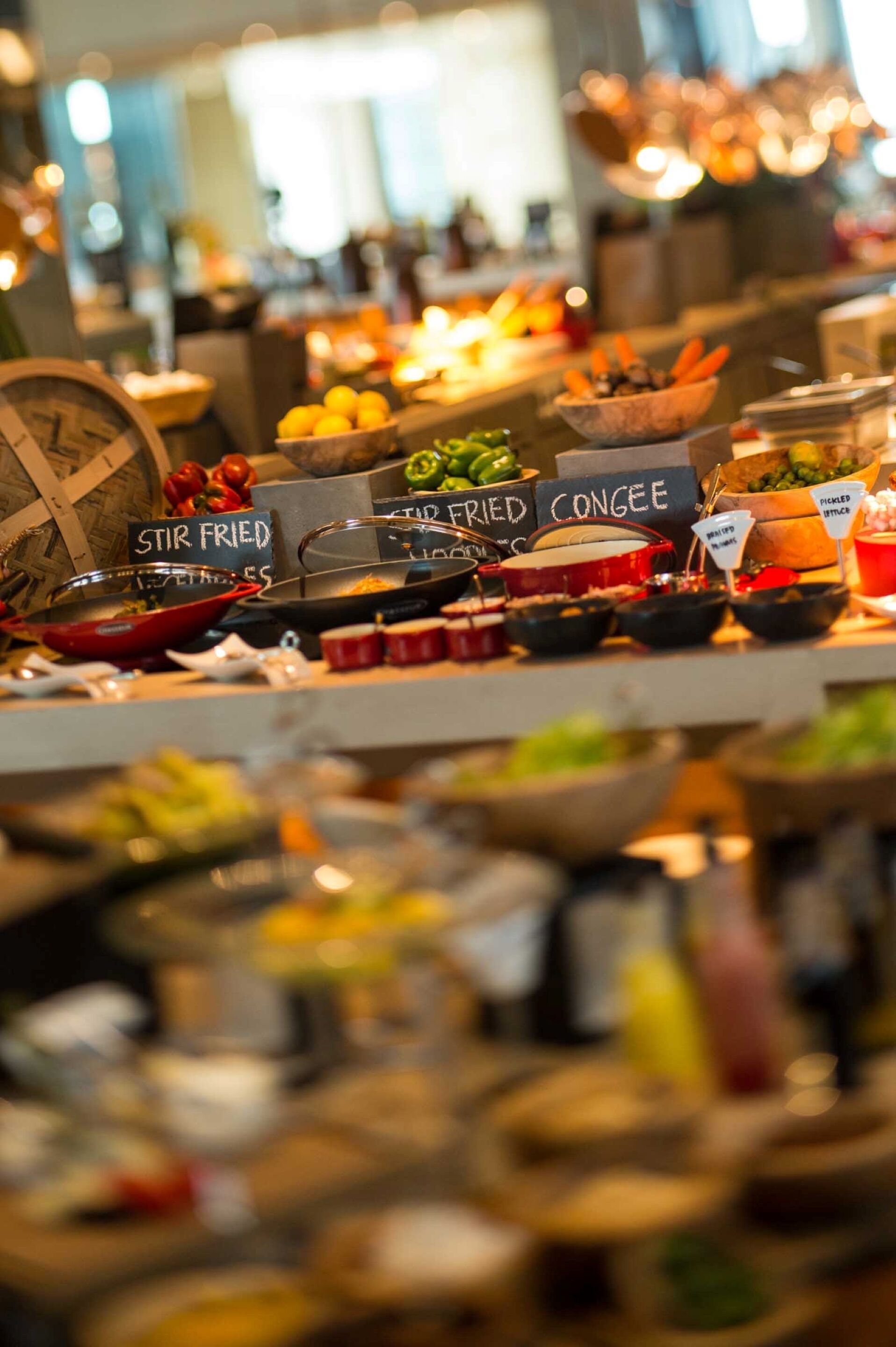 A buffet with labeled dishes including stir-fried, fried congee, and pickled vegetables.