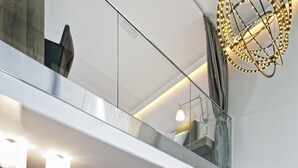 A modern living space with a dining area, a sofa, and a coffee table. - Hotel Diamond Country Club (Atzenbrugg)