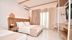 A modern hotel room with a large bed, a desk, and a chair. - Olympion Melathron (Dio-Olympos)