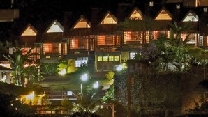 A row of traditional-style buildings with multiple windows, likely part of a hotel or resort. - Pousada do Taxo (Garopaba)