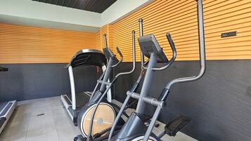 A gym with stationary bikes and a treadmill.