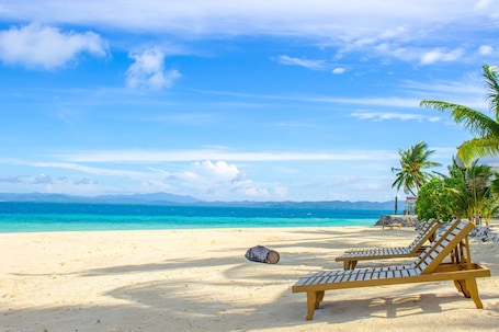 Private beach, white sand, sun loungers, beach volleyball. Modessa Island