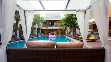 Relax by the serene pool surrounded by lounge chairs and sunbeds, offering a tranquil retreat.