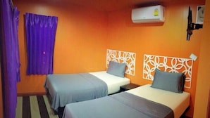 A room with two beds, purple curtains, an air conditioner, and a patterned headboard. - BB House Beach Resort (Pattaya)