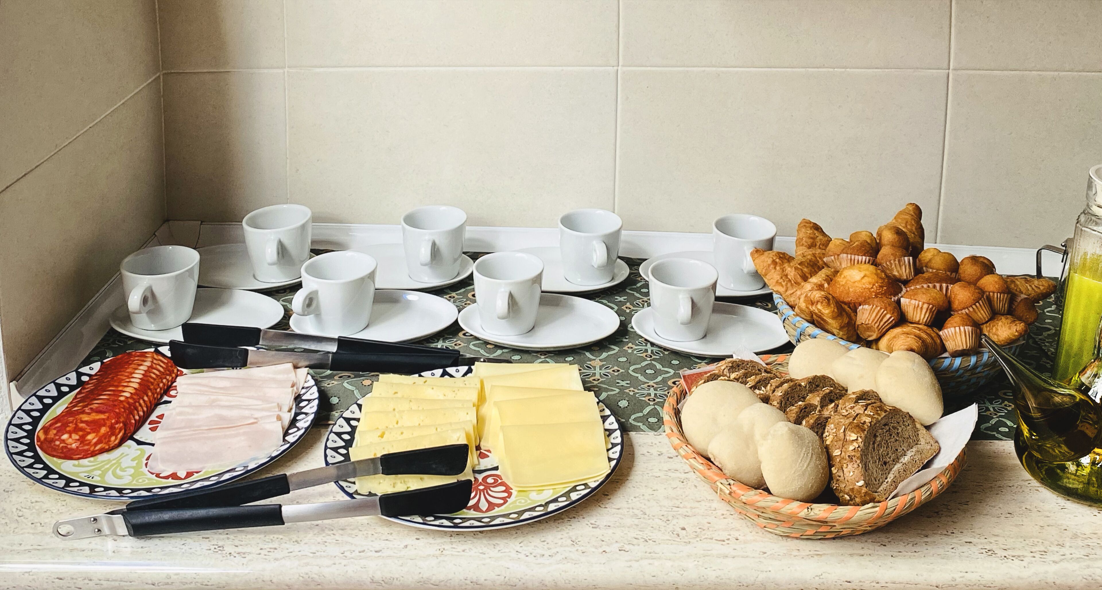 A breakfast buffet with various food items and utensils.
