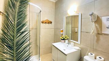 Basic Quadruple Room | Bathroom | Shower, hair dryer, towels, soap