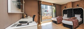 A hotel room with a desk, two beds, a large window, and a balcony. - Dencity Hotel (Istanbul)