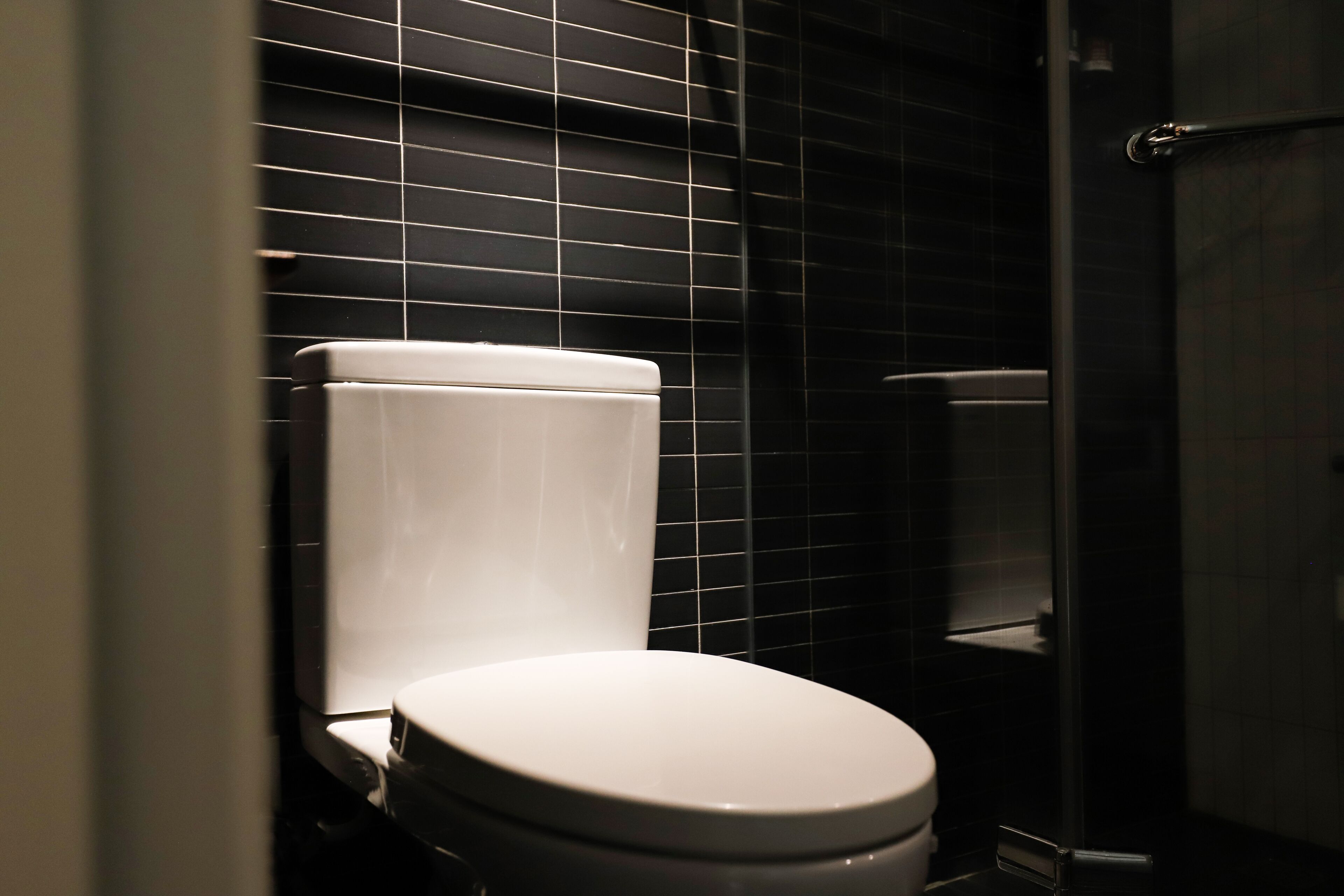 deluxe quadruple room | bathroom | shower, rainfall showerhead, hair dryer, slippers