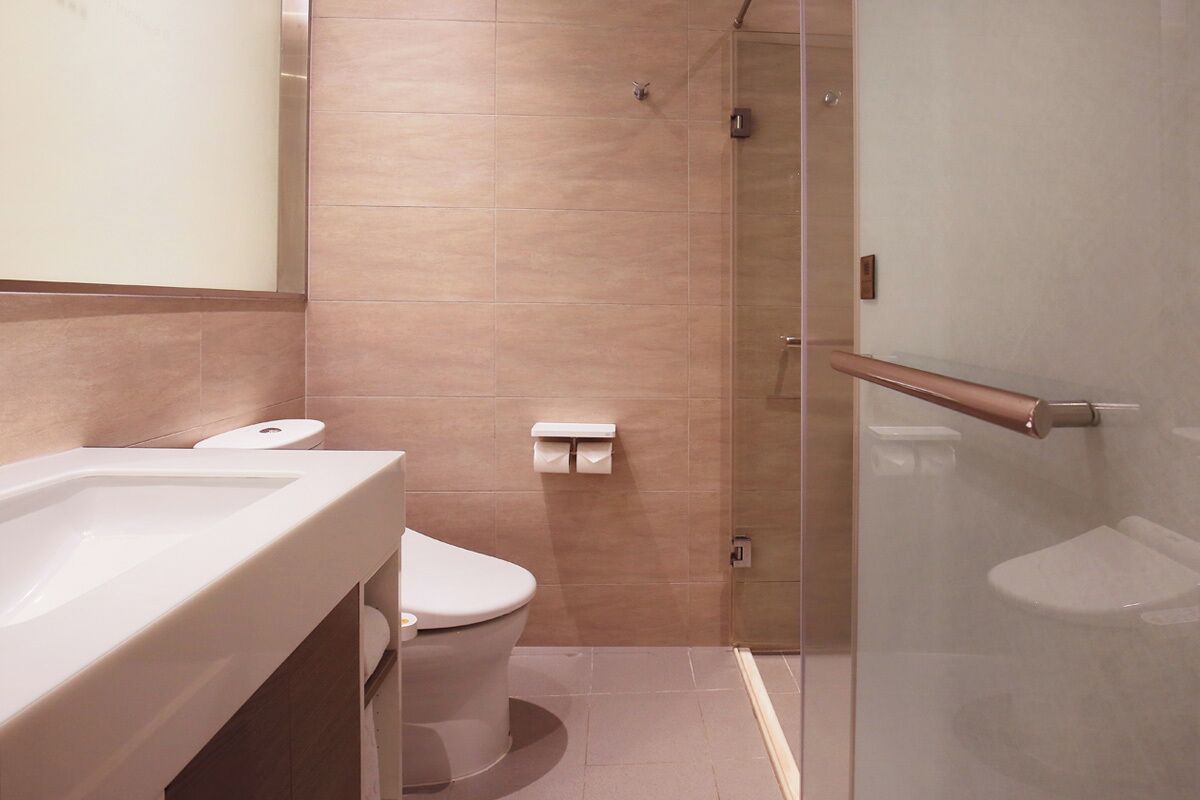 A bathroom with a bathtub, toilet, and shower.